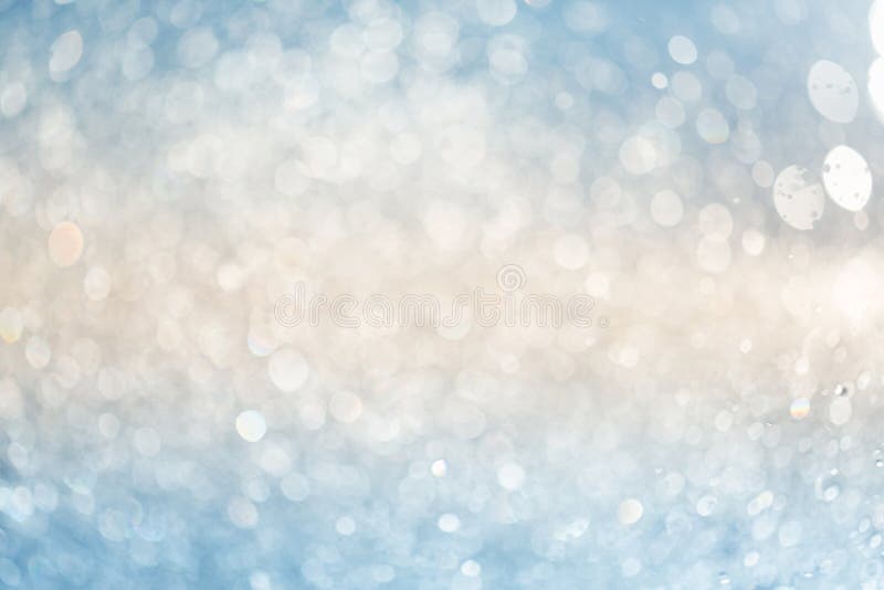 Two-tone abstract background: blurred splashes of water drops in the setting sun. blue and yellow colors