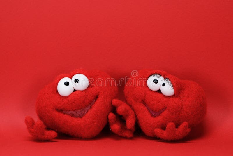 Two toy red hearts on red background with copy space for text, symbol of love, healtcare, valentines day concept. Two toy red hearts on red background with copy space for text, symbol of love, healtcare, valentines day concept