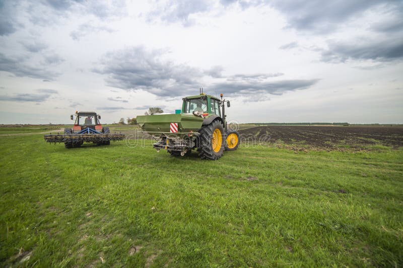 Two Tractors Working in the Field Stock Photo - Image of clouds