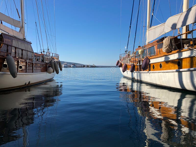 Two traditional wooden boats moored at Bodrum Harbor in Aegean sea. Two traditional wooden boats moored at Bodrum Harbor in Aegean sea.