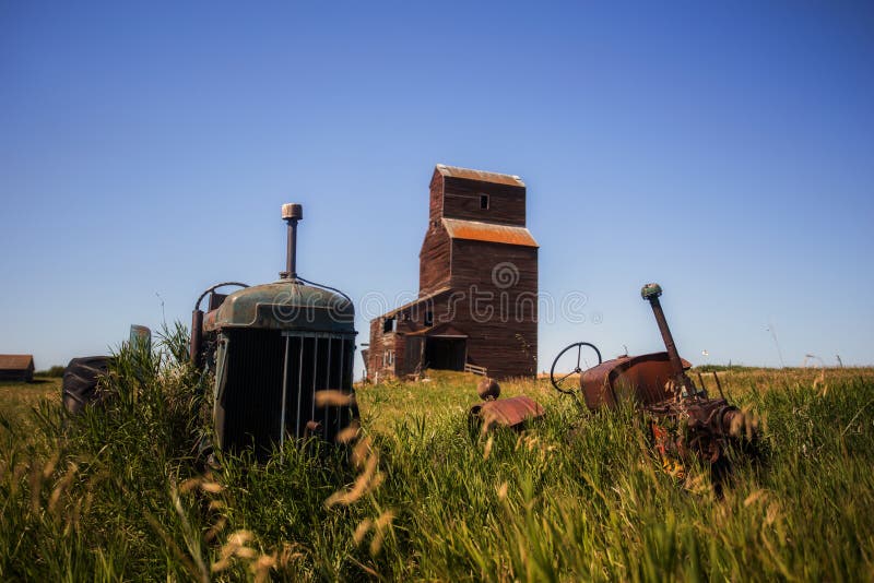 Vintage tractors in front of old grain elevator