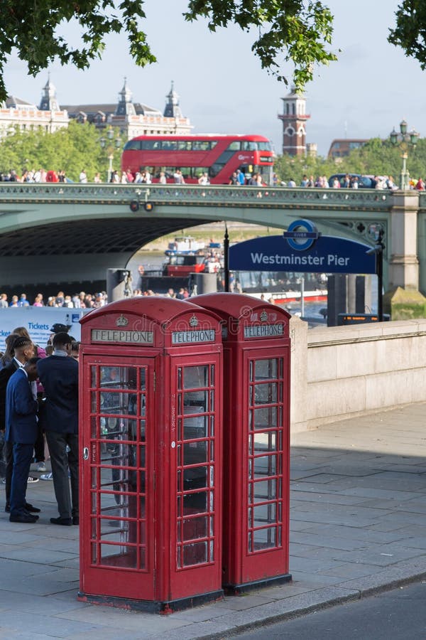 Two Vintage Red Phone Call Boxes and Westminster Bridge in Background