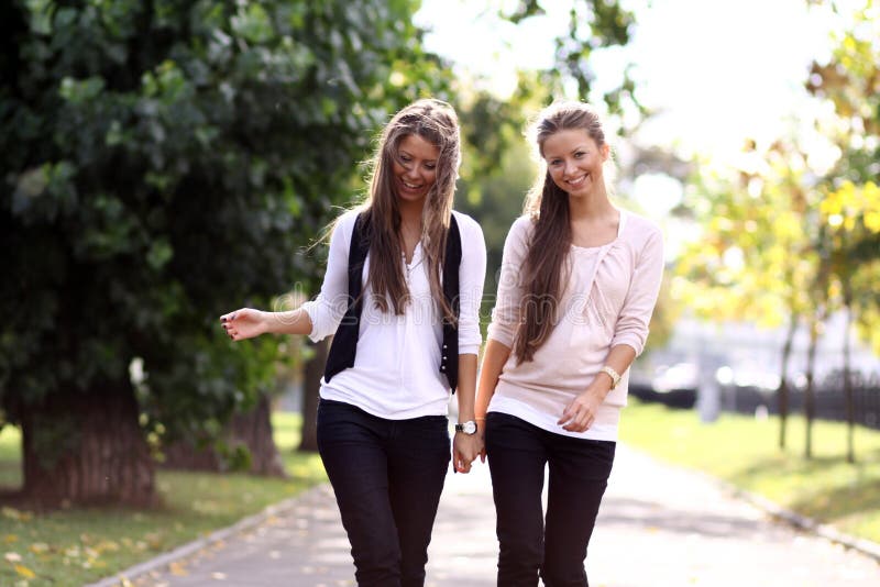 Two walking happy woman