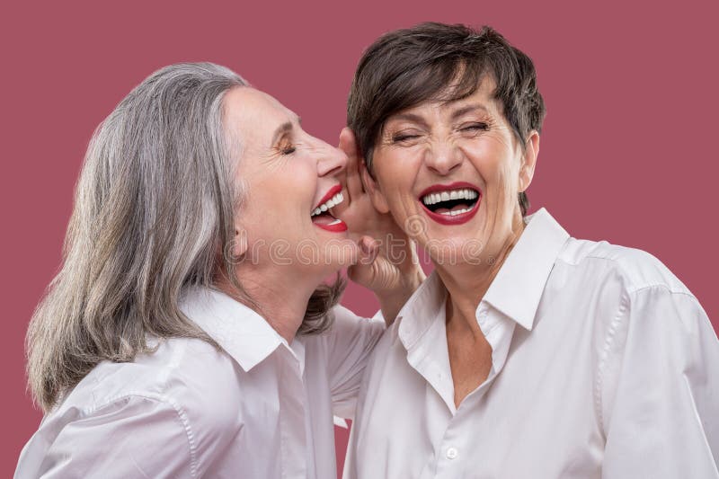 Two Welldressed Women Looking Enjoyed and Having Fun Stock Photo
