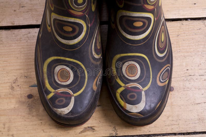 A pair of wellies (gumboots) on a wooden floor. A pair of wellies (gumboots) on a wooden floor.