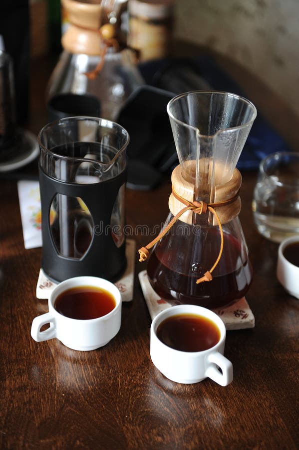 Two White Cups and Pitchers with Coffee. Tasting and Comparison Stock
