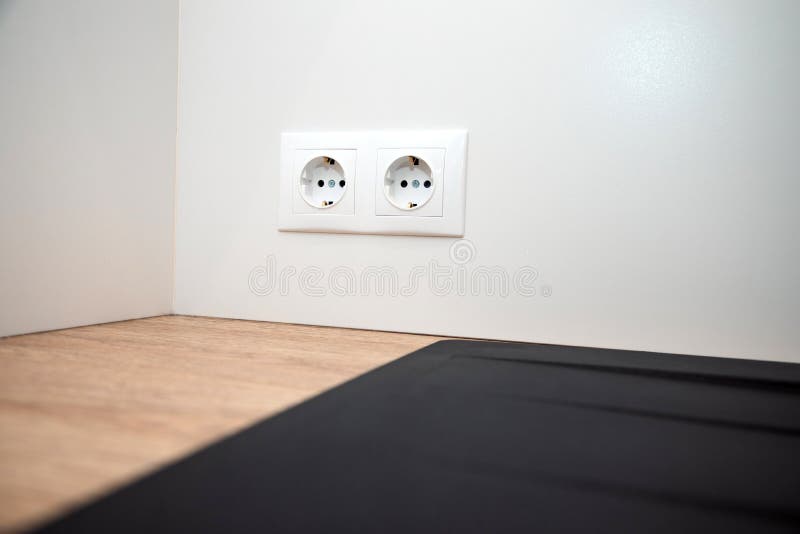 Two White European Electrical Sockets on a White Smooth Wall, Selective
