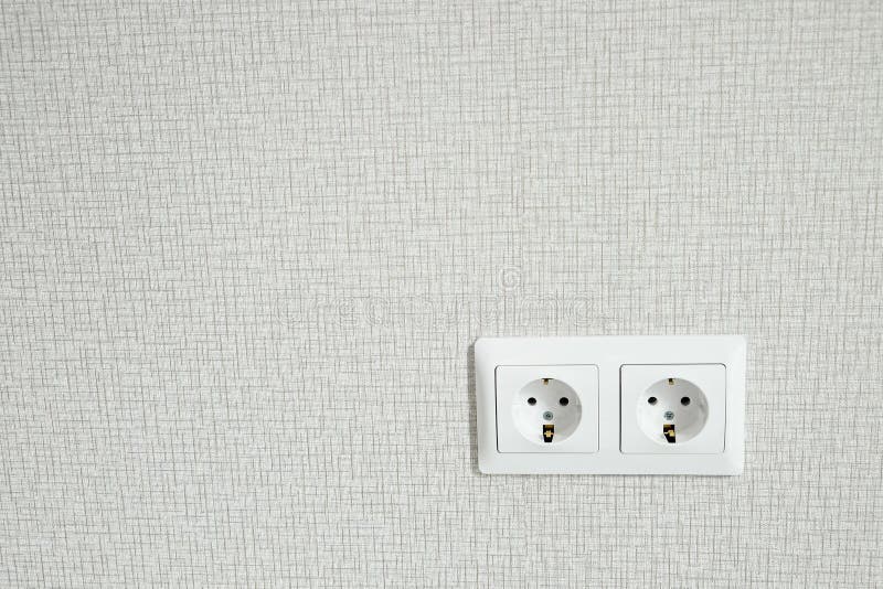 Electric Sockets on Light Wallpaper As a Background. Home Decroration