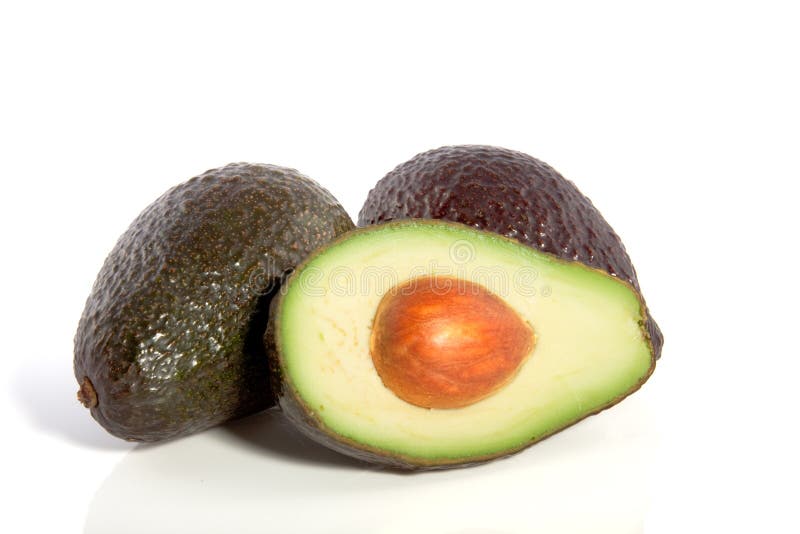 Two whole and one half avocado royalty free stock photo