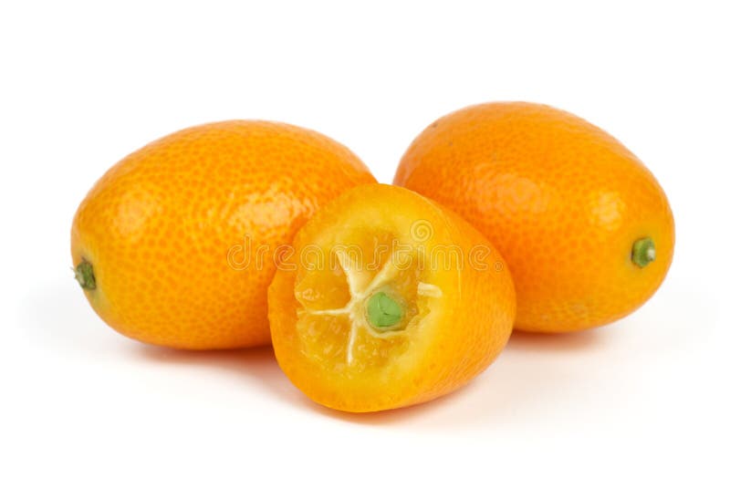 Two whole and sliced kumquat fruits