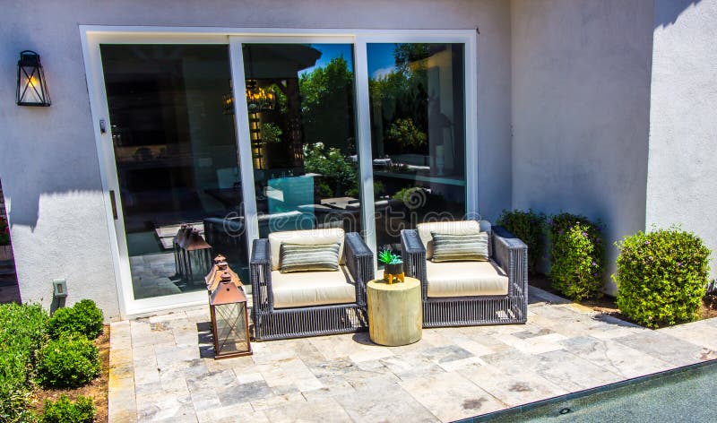 Two Wicker Chairs With Arms On Outside Patio