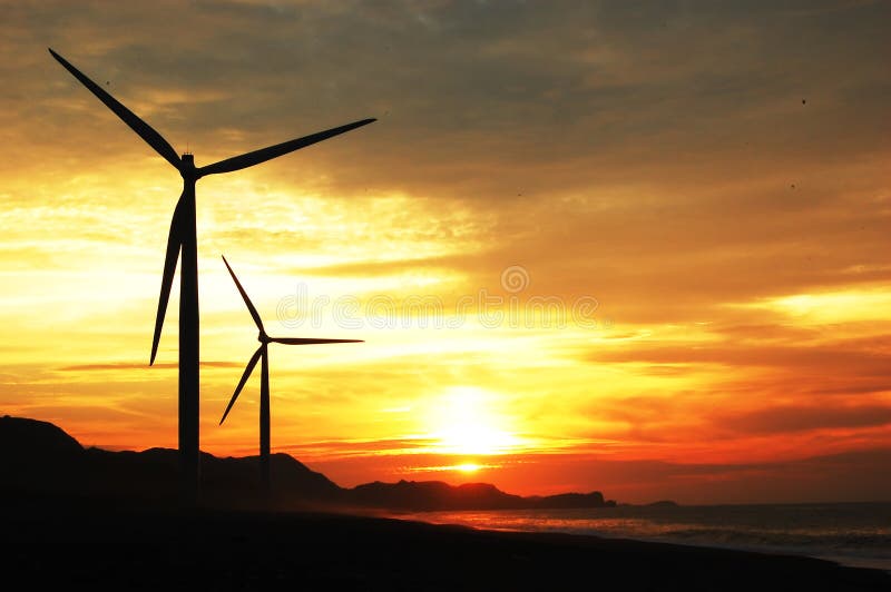 Two wind turbines at sunset