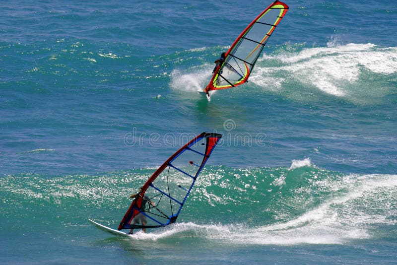 Two Windsurfers Windsurfing in Hawaii