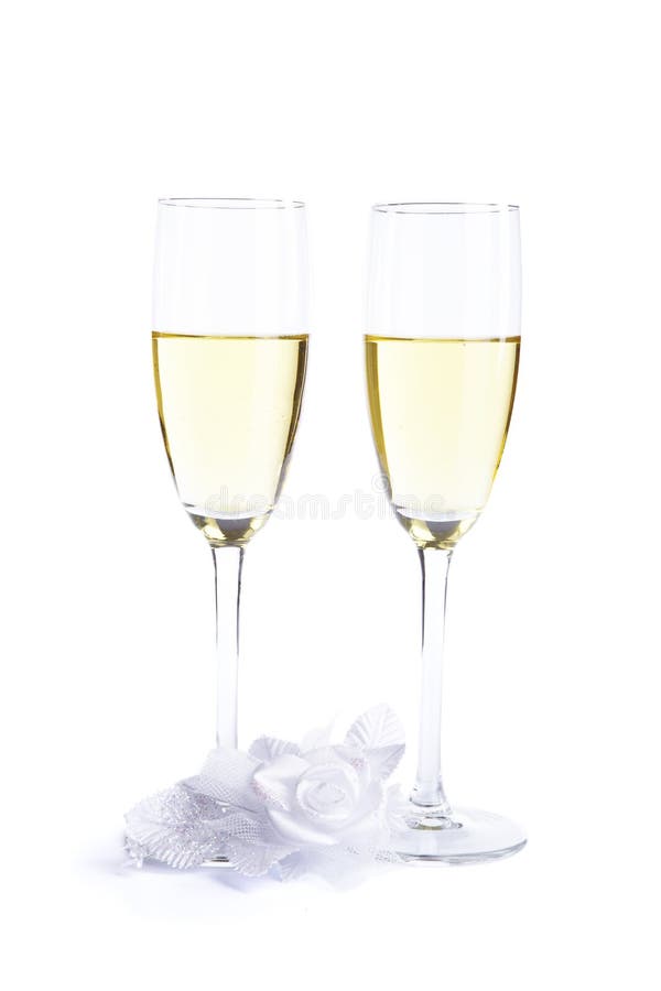 Two wine glasses with champagne and wedding flower