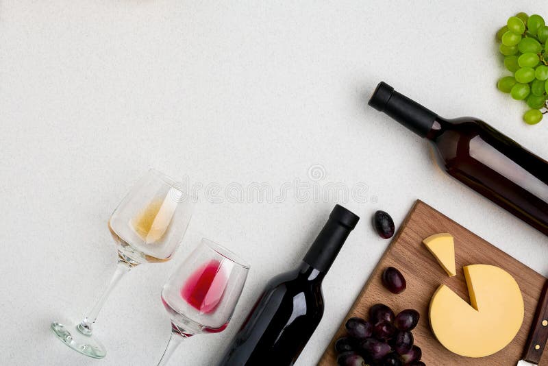 Two wine glasses with red and white wine,bottles of red wine and white wine, cheese on white background. Horizontal view stock images Two wine glasses with red and white wine,bottles of red wine and white wine, cheese on white background. Horizontal view stock images