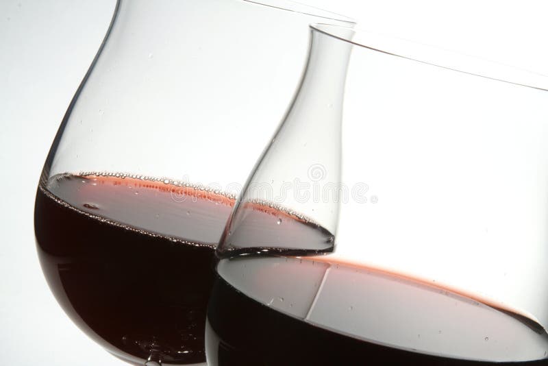 Two wine glasses with red wine stock images