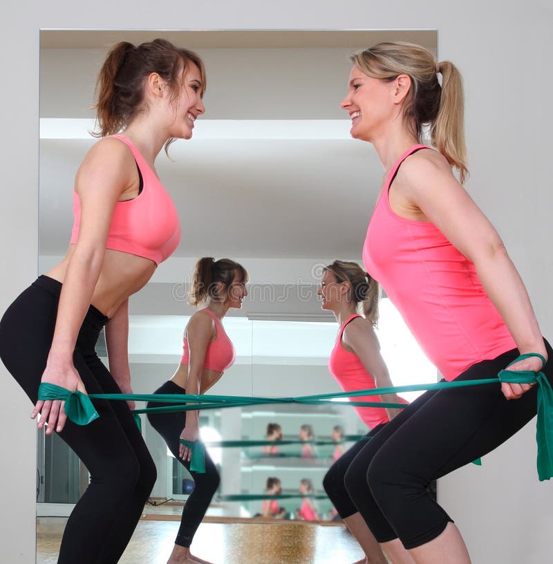 Two woman doing exercise with Fitness Bands royalty free stock image Two woman doing exercise with Fitness Bands royalty free stock image