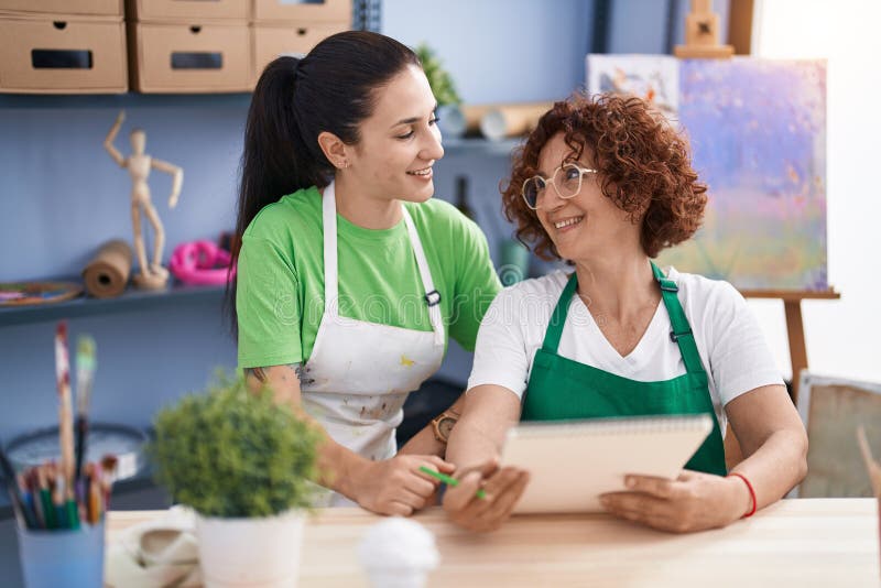 Two Women Artists Drawing on Notebook at Art Studio Stock Photo Image