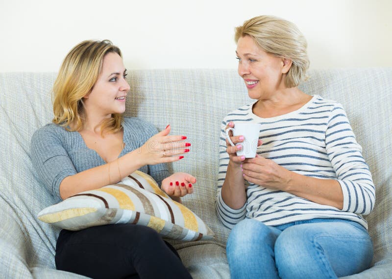 Two Women Drinking Tea and Talking at Domestic Interior Stock Photo ...