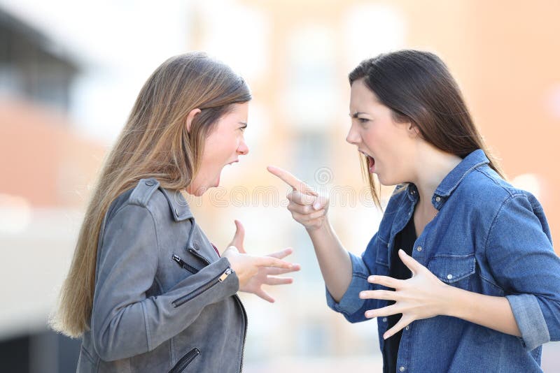 Two women fighting shouting each other in the street royalty free stock photo Two women fighting shouting each other in the street royalty free stock photo