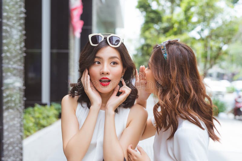 Two women friends shopping together and talking royalty free stock photos.