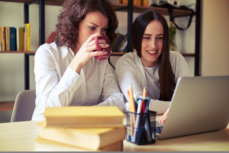 Two women looking at laptop together