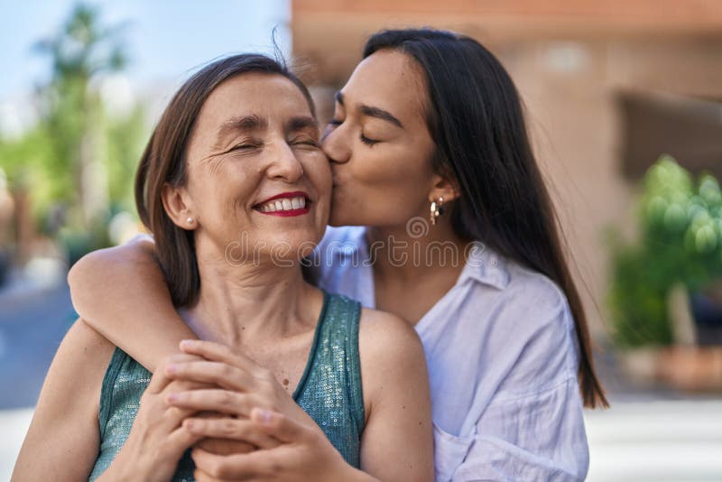 Two Women Mother And Daughter Hugging Each Other Kissing At Street