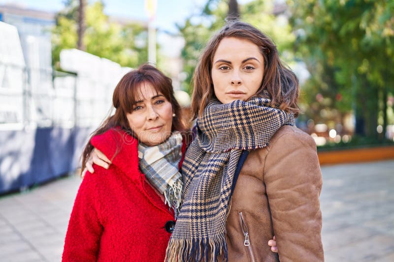 Two women mother and daughter hugging each other with relaxed expression at park royalty free stock photos