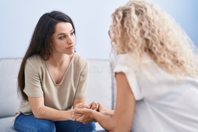 Two women mother and daughter speaking at home stock photos