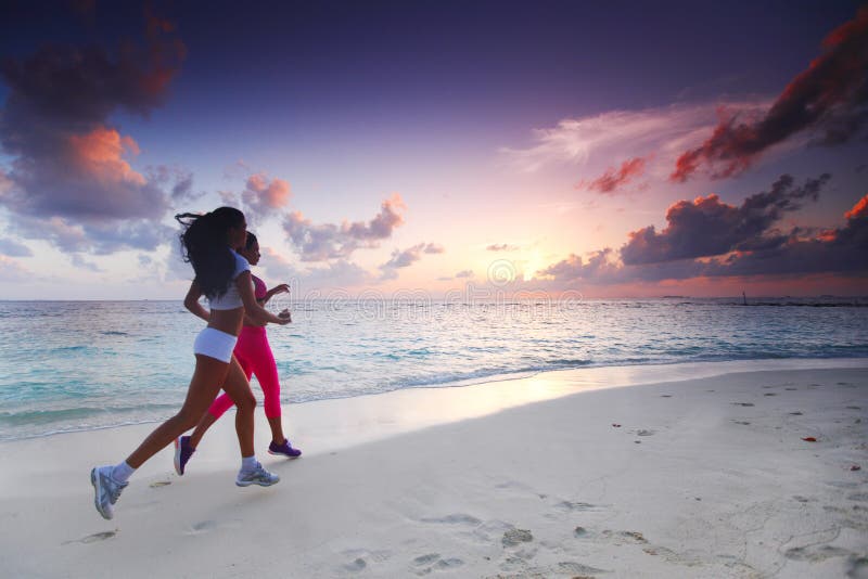 Two women running on beach