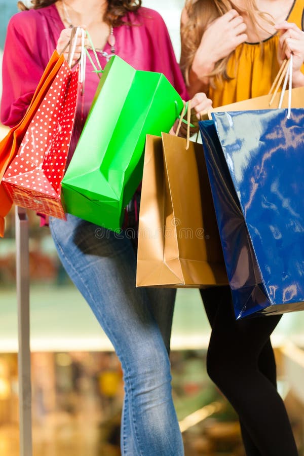 Two Women Shopping with Bags in Mall Stock Image Image of smiling