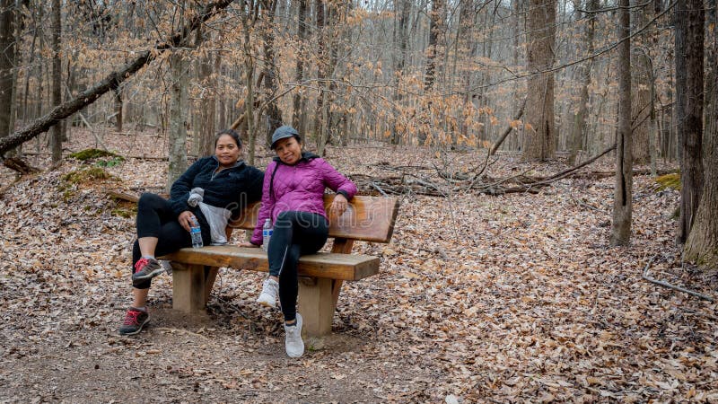 Two Women Sitting On Brown Picnic Mat During Sunset Picture Image