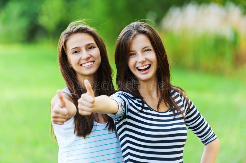 Dos mujer amigos hermoso el sonrie largo tiempo oscuro cabello de pie próximo mano él arrastró.