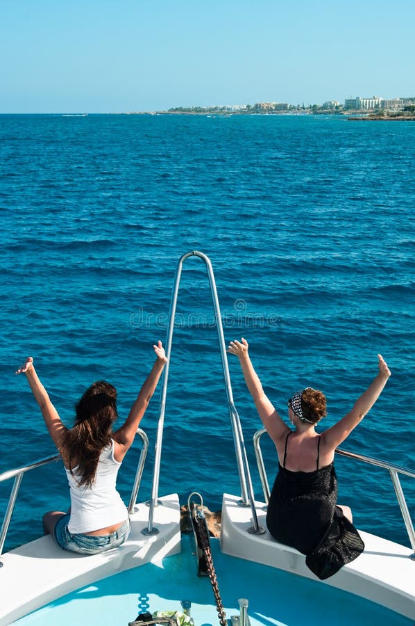 Two women on stern of yacht