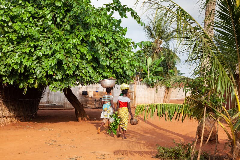 Women walking home from town in Benin