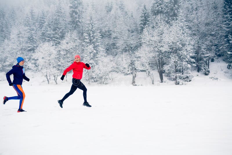 Two women trail running on snow in winter mountains royalty free stock images Two women trail running on snow in winter mountains royalty free stock images