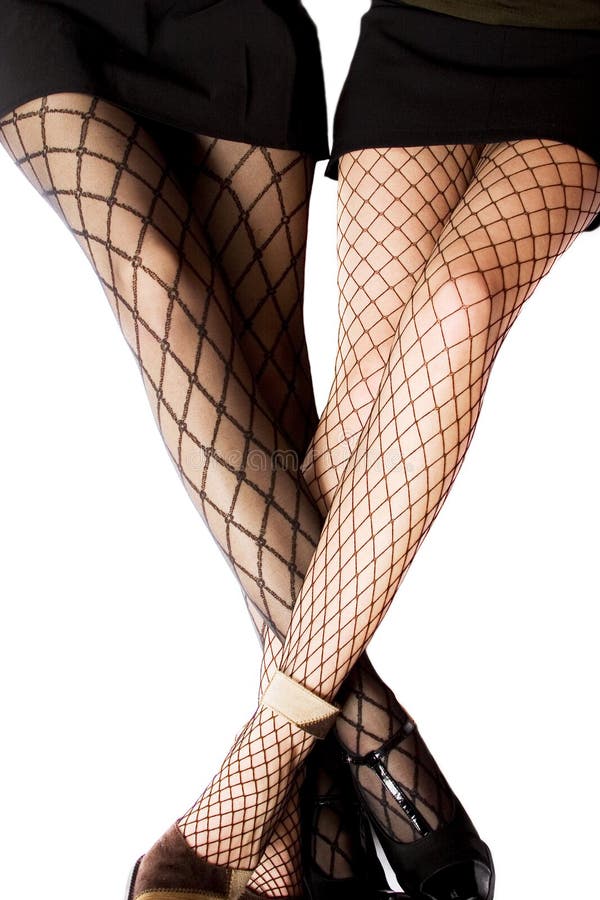 Two women wearing fishnet tights with crossed legs
