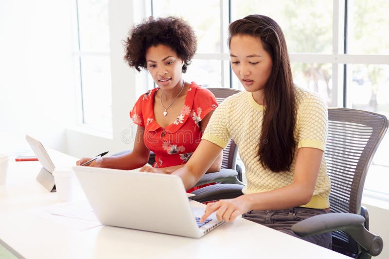 Two Women Working Together In Design Studio