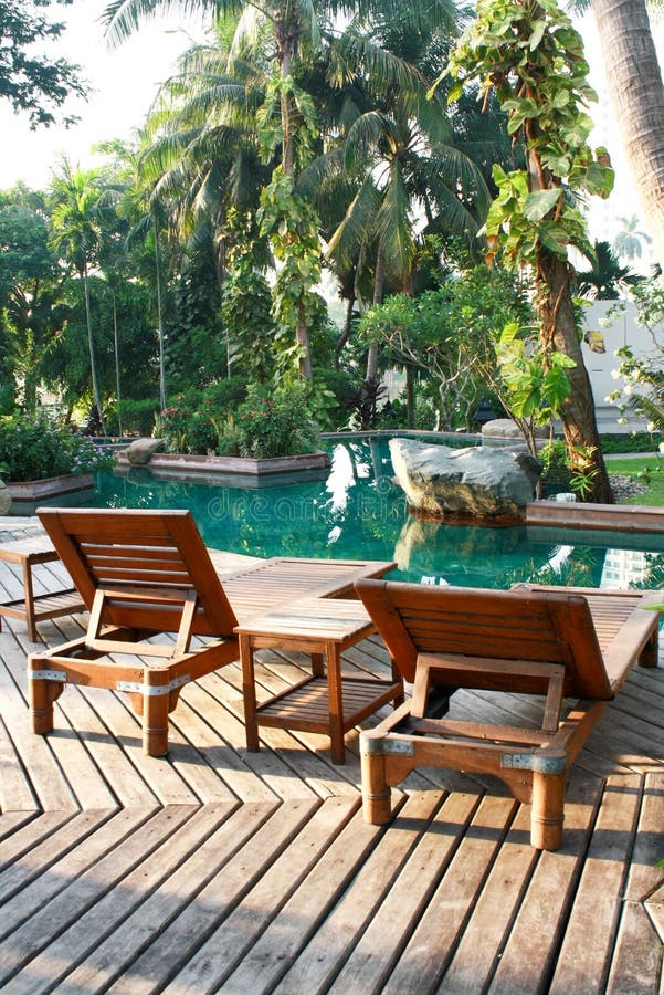 Two wood chair near pool stock image. Image of color 32052277