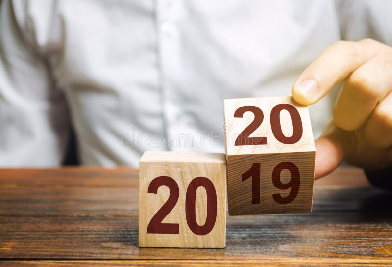 Two wooden blocks with numbers 2019 and 2020. The concept of the beginning of the new year. New objectives. Next decade. Trends and changes in the world. Build plans and goals. Time report