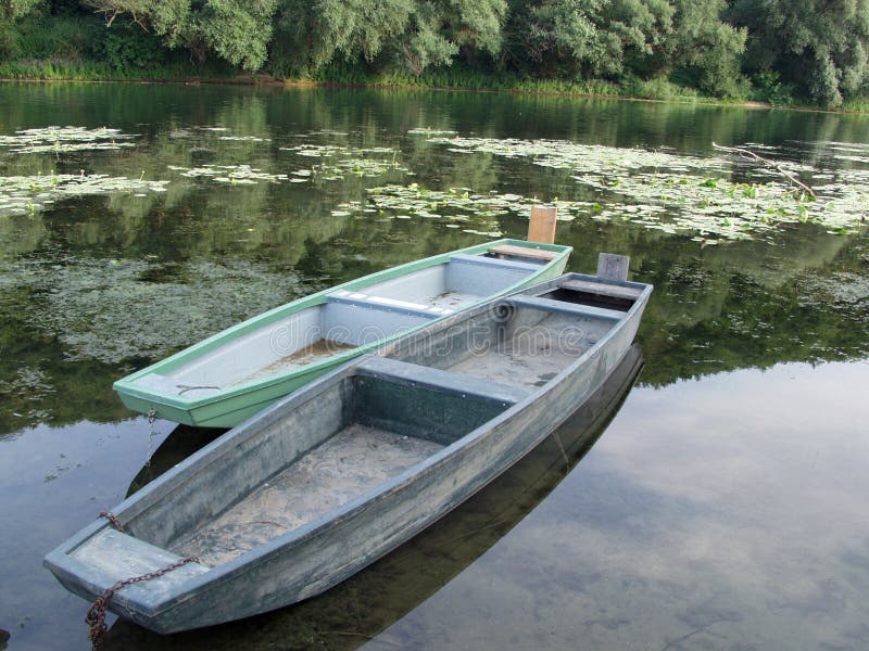 Two wooden boats in a lake