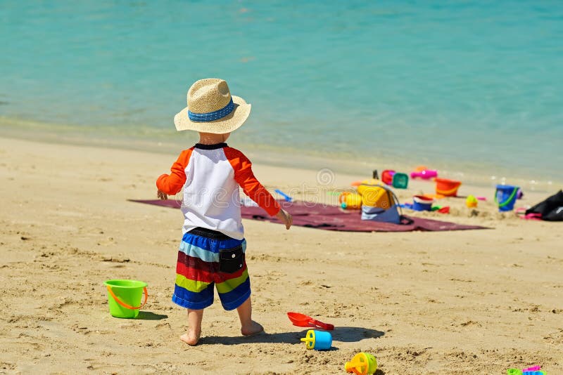 Two year old toddler playing on beach royalty free stock photos