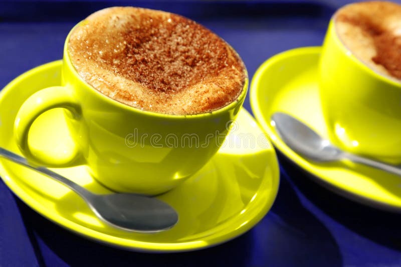 Two yellow coffee cups