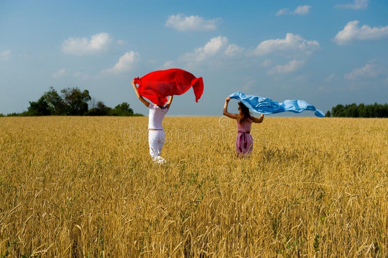 Two young beautiful woman running on the fild