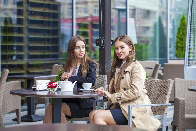 Two young business women having lunch break together