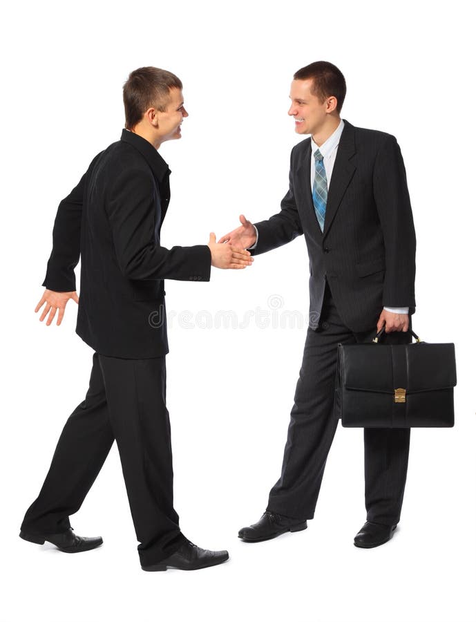 Two young businessmen greet