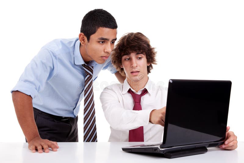 Two young businessmen working together on a laptop