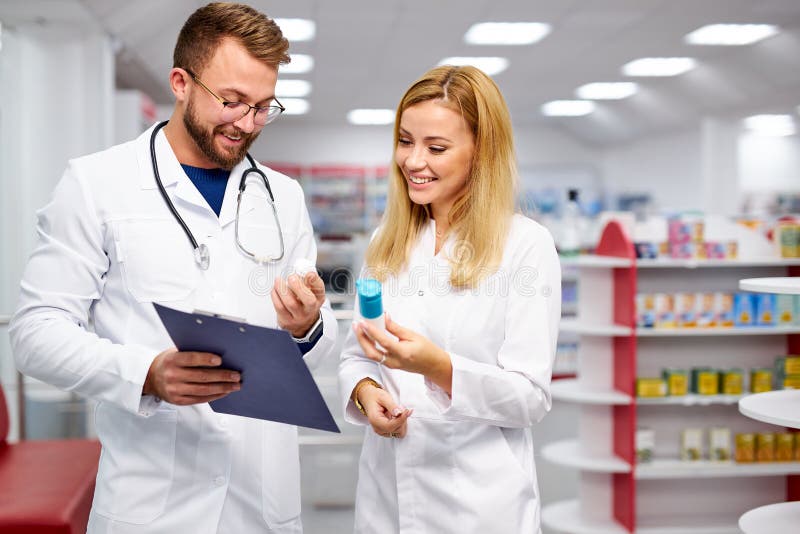 Two Caucasian Pharmacists are Discussing Medication, Using a Digital ...