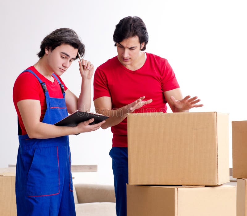 Two Young Contractor Employees Moving Personal Belongings Stock Image