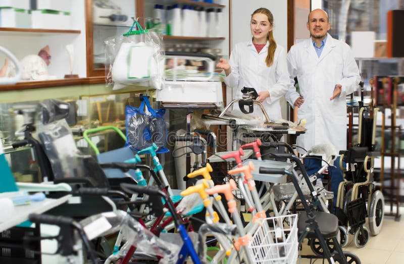 Two Orthopedists Working In Special Store With Orthopaedic Goods Stock